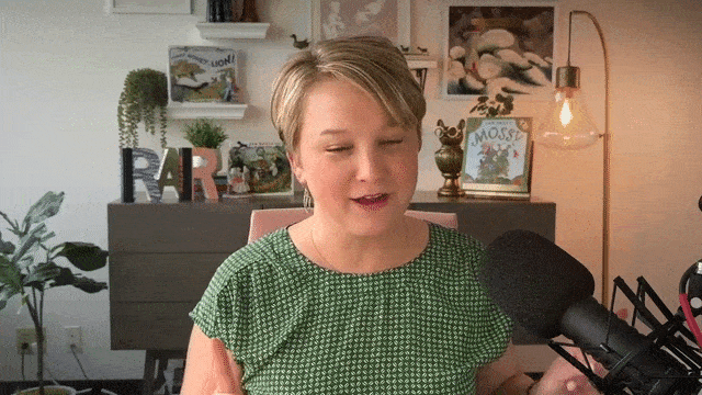 Summer-Adventure-give-me-a-shot-low - Read-Aloud Revival ® with Sarah Mackenzie Woman with short blonde hair in a green dotted blouse speaks into a large microphone in a home recording setup.