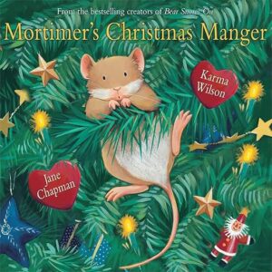 Cover of a children's book: Mortimer's Christmas Manger, a brown mouse in evergreen branches with fairy lights and red heart tags.